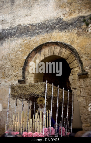 A throne with a Virgin Mary crosses the gate of the Alcazar fortress during Easter Holy Week in Carmona,Seville,Andalusia,Spain Stock Photo