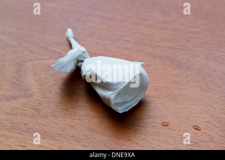 small rose made out of a cocktail napkin placed on a table Stock Photo