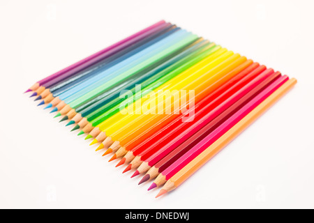 Colored crayons lying side by side on a white background Stock Photo