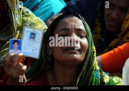 (131224) -- DHAKA, Dec. 24, 2013 (Xinhua) -- A woman mourns when relatives of Rana Plaza victims stage a demonstration in Savar, on the outskirts of Dhaka, Bangladesh, Dec. 24, 2013. Survivors and their loved ones on Tuesday marked the eight-month anniversary of Bangladesh's worst-ever industrial tragedy, while many families express anger and annoyance due to lack of proper aid. Rana Plaza, an eight-story building housing five garment factories, crumbled into a cement grave on April 24 in Savar on the outskirts of capital Dhaka, killing more than 1,130 people, mostly workers. (Xinhua/Shariful Stock Photo