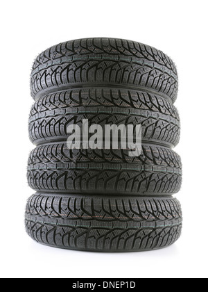 Pile of four winter car tyres shot on white Stock Photo