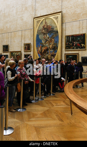 people looking and taking photos in front of the Mona Lisa painting by Leonardo da Vinci, Louvre Museum, Paris, France Stock Photo