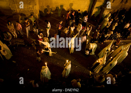 Penitents walk in a street during an Easter Holy Week procession in Cordoba, Andalusia, Spain, April 17, 2011. Stock Photo