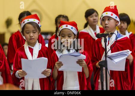 Bangkok, Thailand. 24th Dec, 2013. The children choir sings carols during Christmas services at Holy Redeemer Church in Bangkok. Thailand is predominantly Buddhist but Christmas is widely celebrated throughout the country. Buddhists mark the day with secular gift giving but there are about 300,000 Catholics in Thailand who celebrate religious Christmas. Catholics first came to Thailand (then Siam) in 1567 as chaplain for Portuguese mercenaries in the employ of the Siamese monarchy.  © Jack Kurtz/ZUMAPRESS. Credit:  ZUMA Press, Inc./Alamy Live News Stock Photo