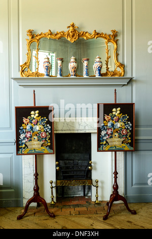 Interior view of Peyton Randolph house in Colonial Williamsburg with original artwork and furnishings displayed in front of fire Stock Photo