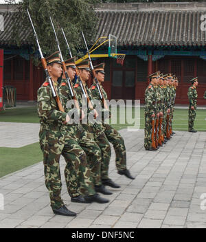 Oct. 26, 2006 - Beijing, Beijing Municipality, People's Republic of China - Camouflage uniformed members of the People's Armed Police Force (CAPF) perform drills with bayoneted rifles at their barracks in the courtyard of the Forbidden City outside the Meridian Gate in Beijing. A paramilitary force mainly dealing with civilian order, they guard government buildings, provide protection to senior government officials, provide security functions at public events and respond to riots, terrorist attacks or other emergencies. (Credit Image: © Arnold Drapkin/ZUMAPRESS.com) Stock Photo