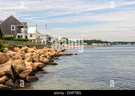 Summer in Niantic, Connecticut looking from Black Point Beach Club to Attawan Beach along the Connecticut shore, June 2013. A quaint small town American shoreline summer community in New England. Summer homes cottages along the rocky coastline. Copy space in the blue sky with cirrus clouds and water of Niantic Bay part of the Long Island Sound which feeds into the Atlantic Ocean. Stock Photo