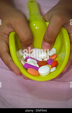 Spoon with Stack of Tablets in Human Hand Stock Photo