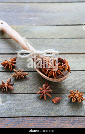 Stars anise on wooden spoon, food closeup Stock Photo