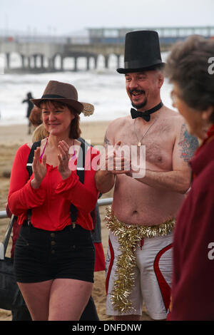 Boscombe, Bournemouth, Dorset UK . 25th Dec, 2013. The Spartans venture into the sea near Boscombe Pier for their traditional Christmas Day swim, despite stormy conditions. Members were in fancy dress, with the Mayor of Bournemouth, Cllr Rodney Cooper attending the event. Credit:  Carolyn Jenkins/Alamy Live News Stock Photo