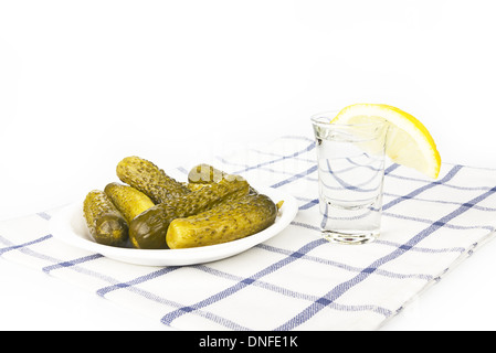 Russian vodka with lemon and salty cucumbers Stock Photo