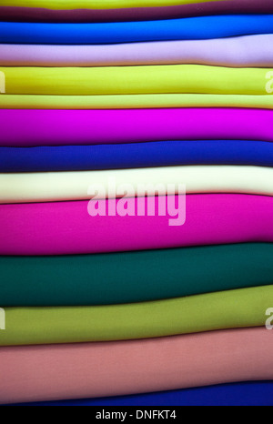 Brightly colored fabric folded and stacked Stock Photo
