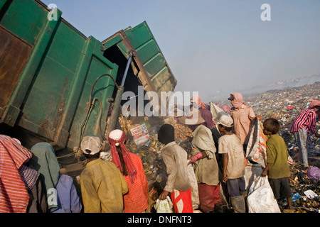 Scavengers are collecting recyclable material as a garbage truck arrives at the Stung Meanchey Landfill in Phnom Penh, Cambodia. Stock Photo