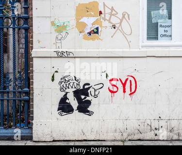 Stencil street art, black and white pointing monkey by SYD in Brick Lane area, London E1 Stock Photo
