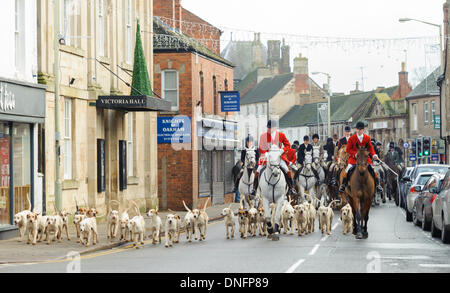 Oakham, Rutland, UK. 26th Dec, 2013. Huntsman and hounds process through Oakham High Street after the Cottesmore Hunt's traditional Boxing Day meet. Credit:  Nico Morgan/Alamy Live News Stock Photo