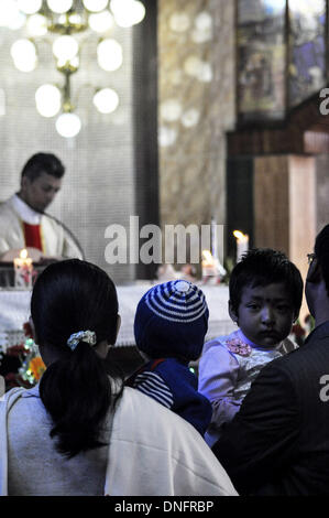 Agartala, Tripura, India. 25th Dec, 2013. Christion people having the blessings in the church during the Christmas Mass in Agartala, capital of the North Eastern state of Tripura. Many Christians went to churches to pay their Christmas prayers across the country. Photo: Abhisek Saha/NurPhoto Credit:  Abhisek Saha/NurPhoto/ZUMAPRESS.com/Alamy Live News Stock Photo