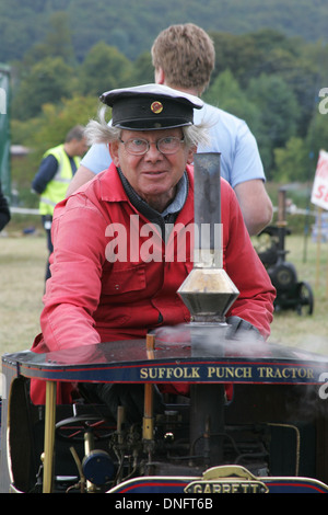 man male driver riding a tiny vintage traction engine Stock Photo