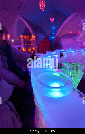 Guests enjoying an appletini drink at the blue ice bar at the Aurora Ice Museum Chena Hot Springs Alaska USA Stock Photo