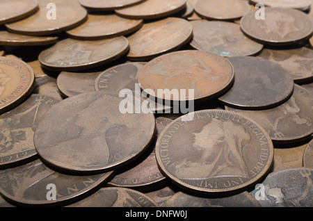 old currency uk penny 1d with King George V and Queen Victoria worn value small change Stock Photo