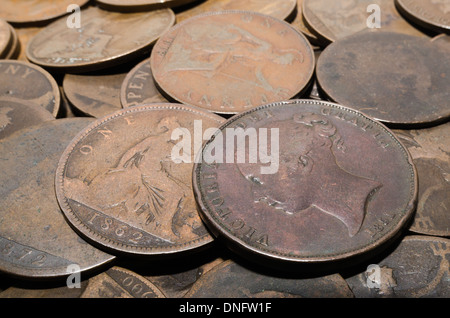 old currency uk penny 1d with King George V and Queen Victoria worn value small change Stock Photo
