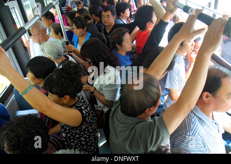 Beijing China,Chinese,Guang An Men Nei Da Jie,Guanganmen Inner Street,public bus,coach,inflight,passenger cabin,crowded,passenger passengers rider rid Stock Photo