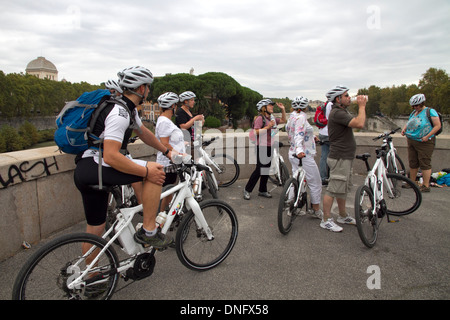 Cyclists group on Tiber river bridge Rome Italy Stock Photo