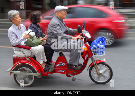 Beijing China,Chinese,Dongcheng District,street,traffic,Asian man men male,adult,adults,woman female women,senior seniors citizen citizens,electric tr Stock Photo