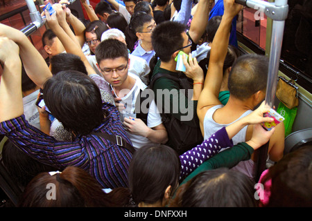 Beijing China,Chinese,Xicheng District,Guang An Men Nei Da Jie,Guanganmen Inner Street,public bus,coach,passenger passengers rider riders,crowded,stan Stock Photo