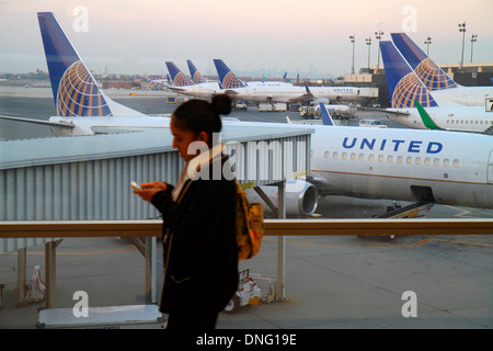 Newark New Jersey,NJ,Northeast,Newark Liberty International Airport,EWR,terminal,gate,tarmac,window,United Airlines,airliners,parked,adult,adults,woma Stock Photo