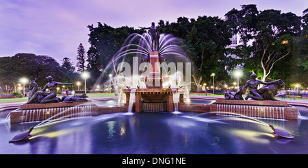 Australia Sydney central Hyde Park Archibald Fountain front wide panoramic view at sunset illuminated lights show Stock Photo