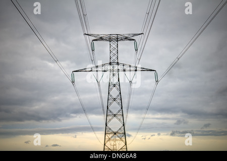 high voltage pylons silhouette cloudy sky background Stock Photo - Alamy
