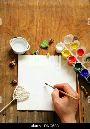 painting set - brushes, paints (gouache) on old wooden table Stock Photo