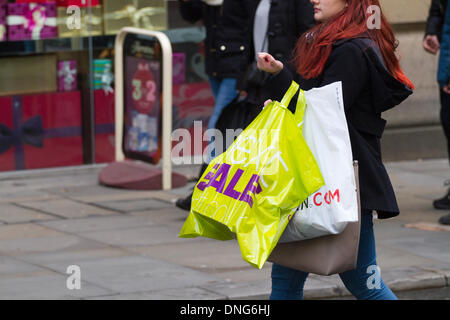 Manchester, UK 27th December, 2013.    Bargain-hunters got an early start as they flocked into Manchester city centre for the start of the sales. The shopping centre reported the average spend per customer is the highest the year has seen so far. Early indications have shown a promising start to the post-Christmas sales. The Arndale is a branded shopping centre and a lot of retailers are on sale all the time, out to sell at the best prices, so people can get the ‘ Manchester look’ for  less. Conrad Elias/Alamy Live News Stock Photo