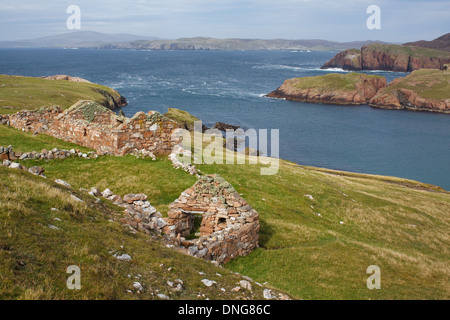 The old haaf fishing station at South Ham on the island of Muckle Roe, Shetland Islands. In the distant is Ronas Hill. Stock Photo