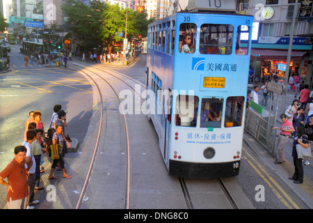 Hong Kong China,HK,Asia,Chinese,Oriental,Island,Wan Chai,Hennessy Road,businesses,district,double decker tram Tramways,Asian adult,adults,woman female Stock Photo