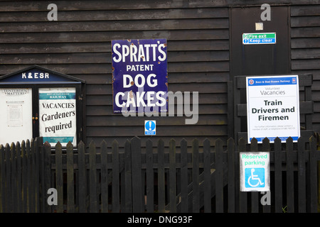 Old fashioned metal advert for Spratts Dog Cakes and job vacancies, Tenterden station, Kent & East Sussex Railway, England Stock Photo