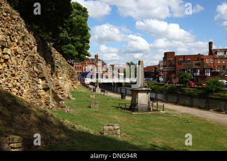 Outer wall of Tonbridge castle and Riverside Walk / Weald Way footpath alongside River Medway, High Street bridge in background, Kent, England Stock Photo