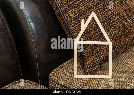 Model house made of wooden sticks placed in room interior. Stock Photo