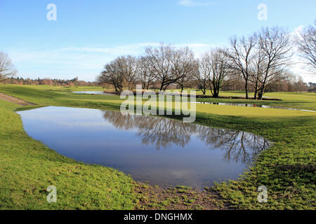 Wisley Golf Course, Surrey, England, UK. 28th December 2013. After the storms across the UK over Christmas, Saturday was a calm and sunny day in Surrey. However there were several new "water hazards" on Wisley Golf Course which had to close after a combination of torrential rain and the River Wey bursting its banks had left many parts of the course under water. Credit:  Julia Gavin/Alamy Live News Stock Photo