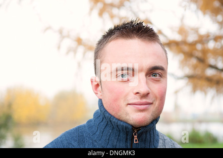 Portrait of young handsome man in autumn park Stock Photo
