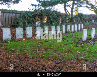 A row of 13 war graves of German Airmen killed in World War 2 and buried in the churchyard at Brandesburton East Yorkshire UK Stock Photo