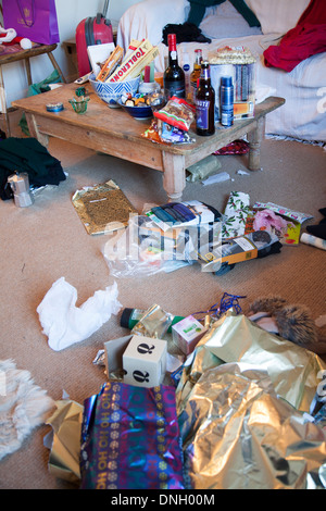 Mess of Christmas presents and wrapping paper scattered around a home, UK Stock Photo