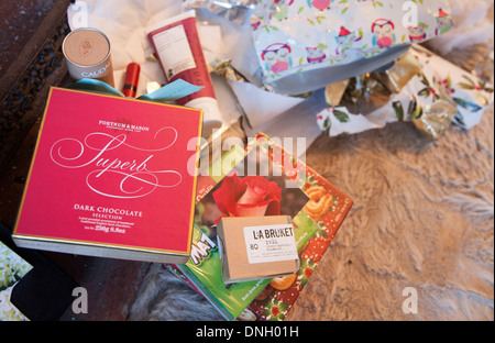 Mess of Christmas presents and wrapping paper scattered around a home, UK Stock Photo