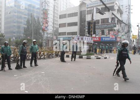 Dhaka, Bangladesh. 29th Dec, 2013. Bangladeshi police stand guard in front of the office of the main opposition Bangladesh Nationalist Party (BNP) in Dhaka on December 29, 2013. Opposition leader Khaleda Zia has said that the government is illegal, undemocratic and should step down immediately. Stock Photo