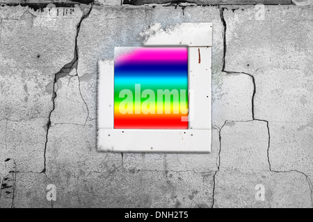 Old cracked wall with a window painted in rainbow Stock Photo