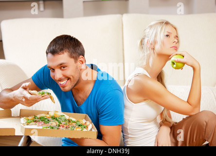 couple eating different food Stock Photo