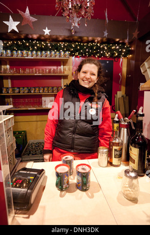 Gluhwein stall, mulled wine for sale with stallholder,  at the Cologne Christmas market, Cologne ( Koln ), Germany Europe Stock Photo