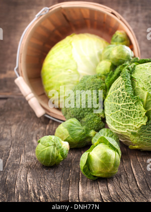 Still life with assortment cabbages on wooden background Stock Photo