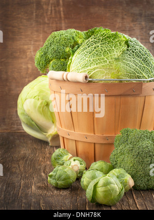 Still life with assortment cabbages on wooden background Stock Photo