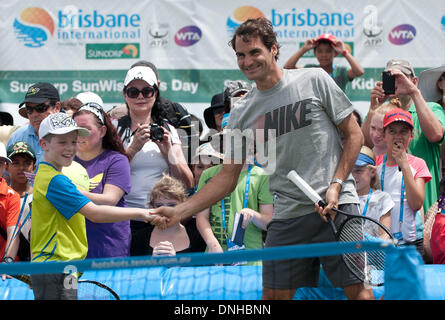 Brisbane, Australia. 30th Dec, 2013. Roger Federer of Switzerland plays with kids during 'Kids day' event at Brisbane International tennis tournament in Brisbane, Australia, Dec. 30, 2013. Credit:  Bai Xue/Xinhua/Alamy Live News Stock Photo